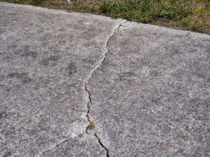 large cracks in concrete driveway