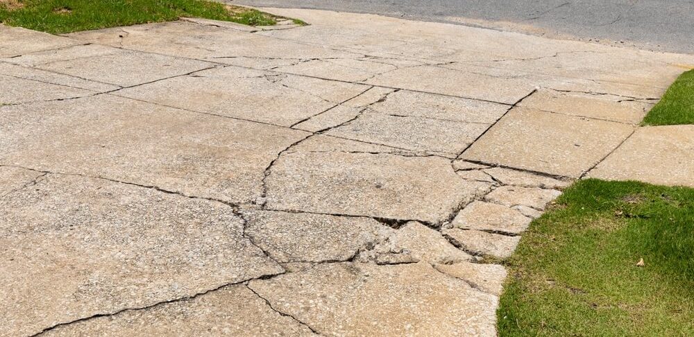 large cracks in concrete driveway